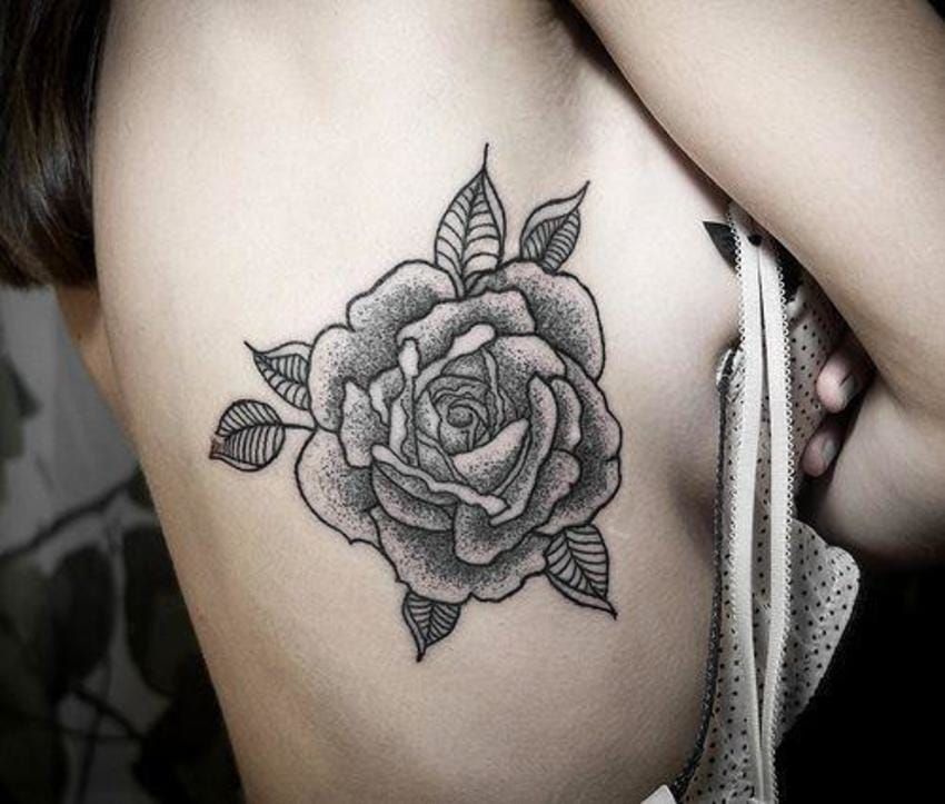 Beautiful blackwork sideboob rose, artist unknown.