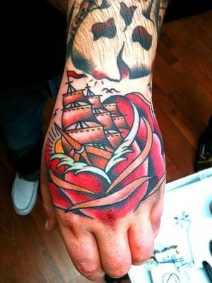 Traditional rose with ship hand tattoo, really cool idea.