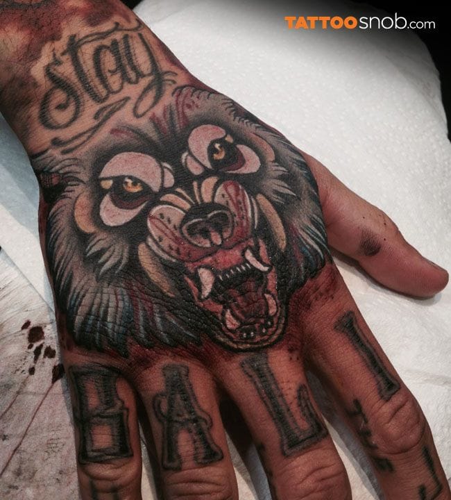 Great wolf hand tattoo by Heath Clifford