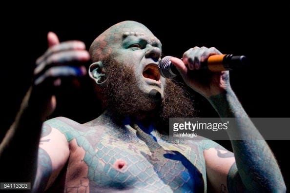 Singing in his band, via Getty