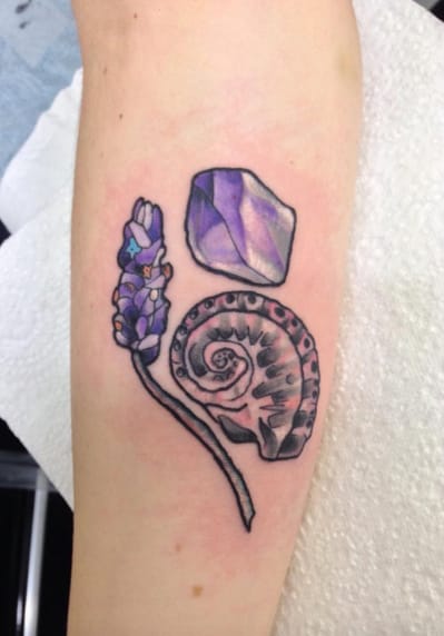 Check out this abstract gem-like lavender tattoo by @darciekaportattoo (photo credit Instagram).