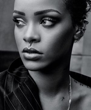 Rihanna's small and simple cross tattoo on her left collarbone, photo by photographer Craig McDean, nytimes.com