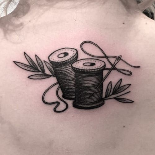 Traditional needle and thread tattoo