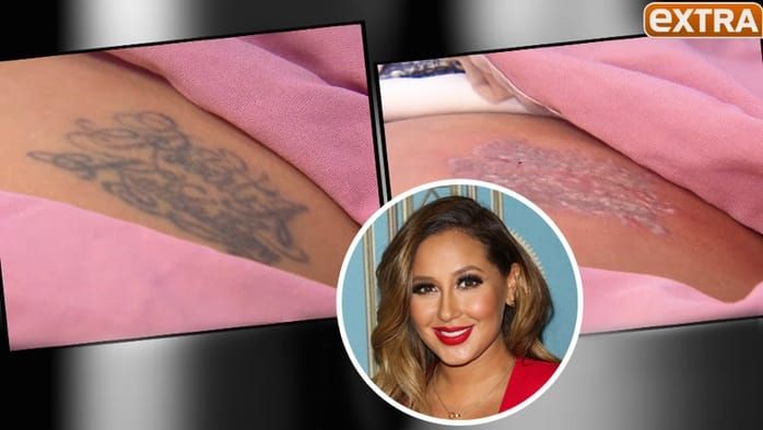 Adrienne Bailon had her ex's name ink on her bum, but had it removed on the show EXTRA