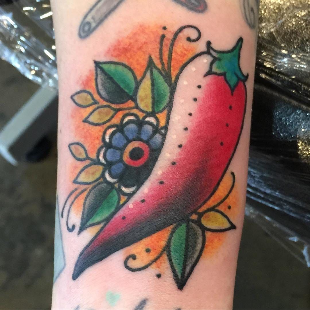Traditional style tattoo of a woman with red chili