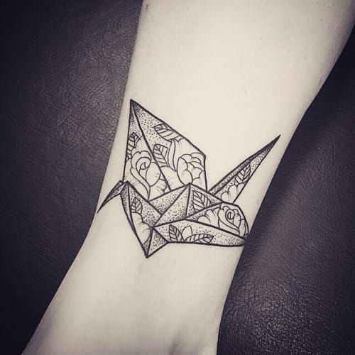 Paper cranes can work beautifully as wrist tattoos for women, this piece by kaditattoo #papercrane #geometric #rose #flower