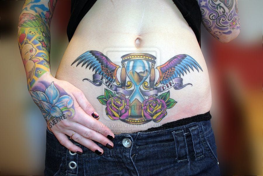 Colorful stomach piece by Charlie of Getatattoo.