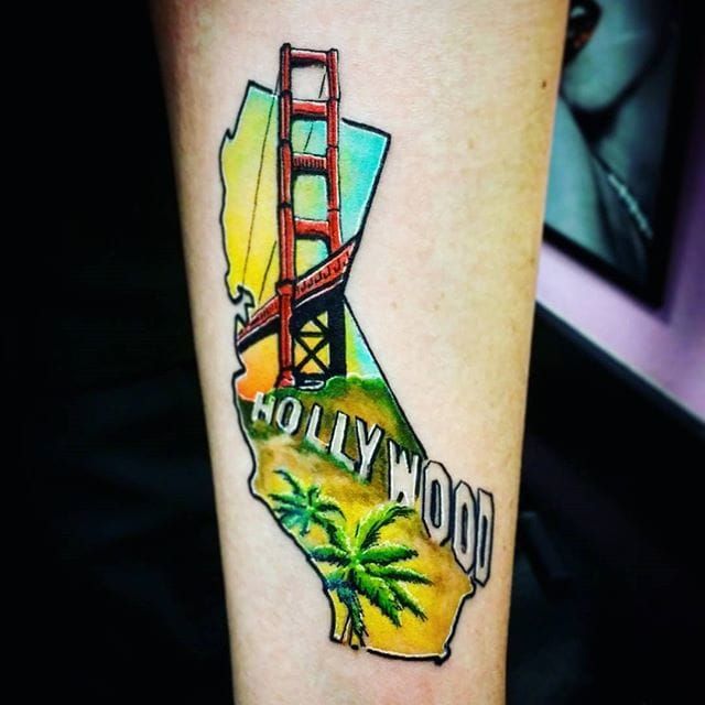 Golden Gate circle tattoo on the right inner forearm