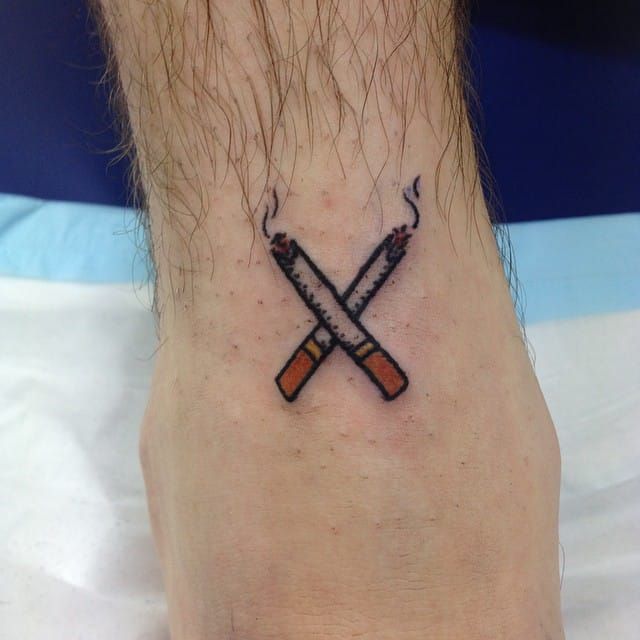 Crossed cigarettes by Elliot Crombie