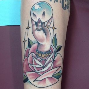 hand holding crystal ball tattoo