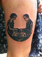 Tattoo by Simon Erl inspired by a vintage illustration of a couple playing the ouija board game.