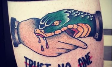 The Hand that Bites: Snake Handshake Tattoos