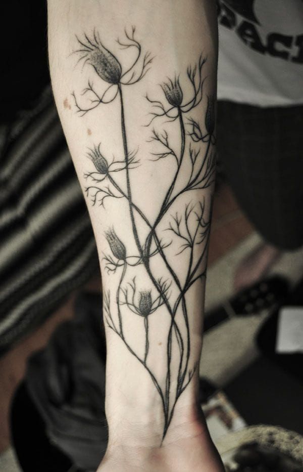 Elegant plant tattoo by Lionel Fahy.