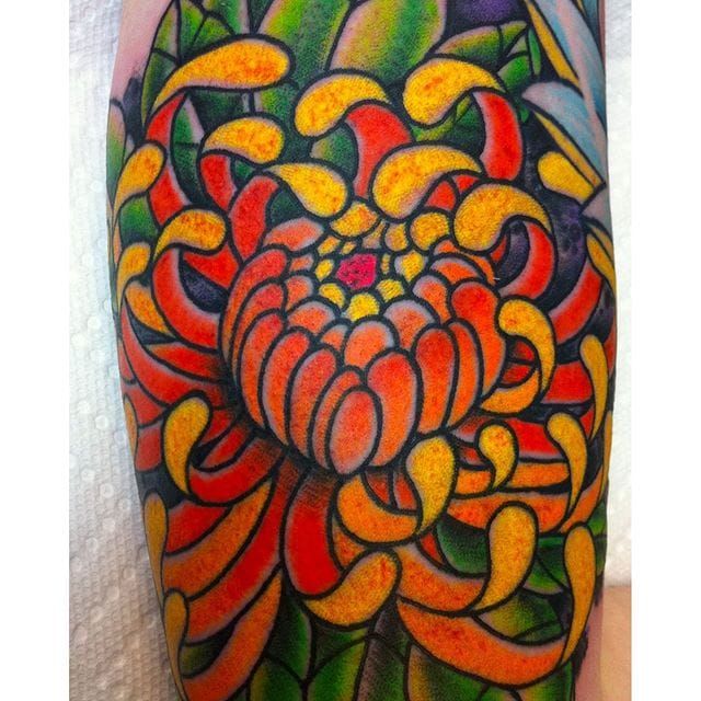 Red chrysanthemum tattoo on the right side of the