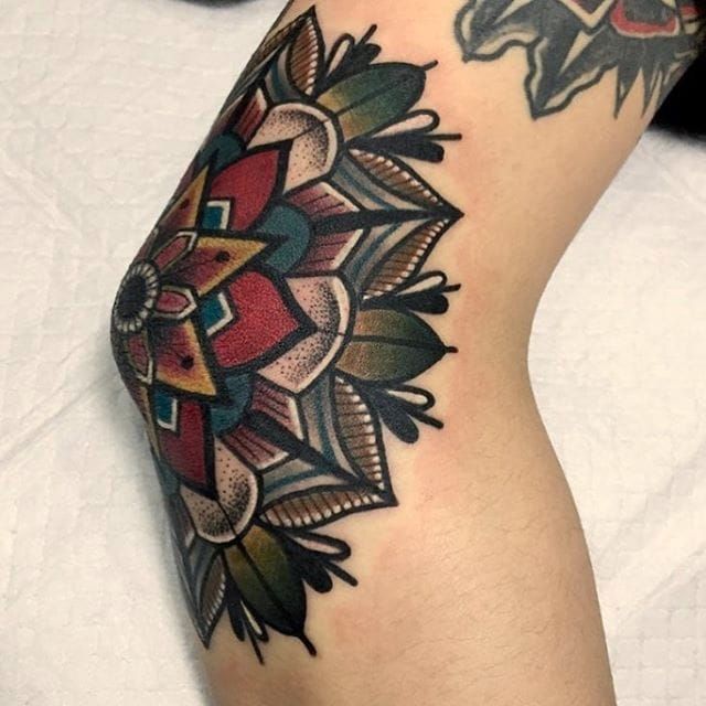 Elbow tattoo of a mandala by tattoo artist André de