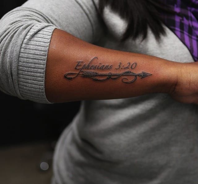 Scripture on the outer forearm, pristine work by Bang Bang.