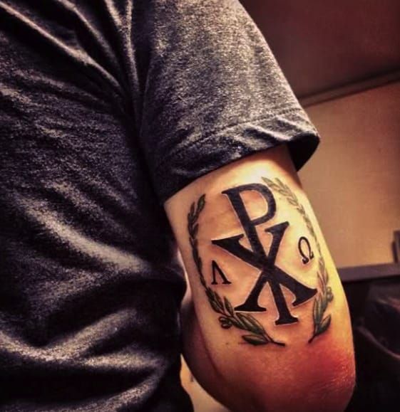 The back of the arm is fitting for this design. XP is Christ in Greek and the symbols on either side are also Greek for Alpha and Omega. In total the composition reads; "Christ, Alpha and Omega, beginning and the end."