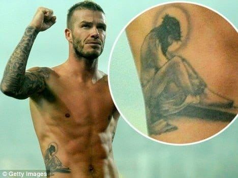Athlete David Beckham celebrating his tattoo of Jesus on the ribs.