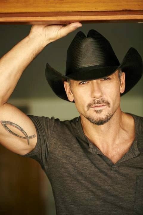 The Christian fish was once a symbol used to mark places where believers could meet in secret because doing so was illegal ><> Thankfully we now have freedom of worship and religion, so this tattooed cowboy can show it off as long as he likes.