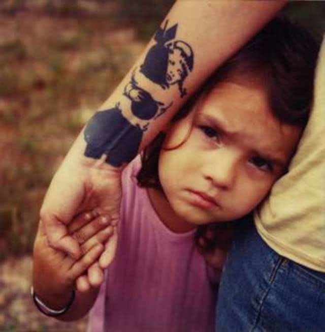 The Girl with a bomb tattoo and this little girl are making a strong photo, by Mike Brodie.
