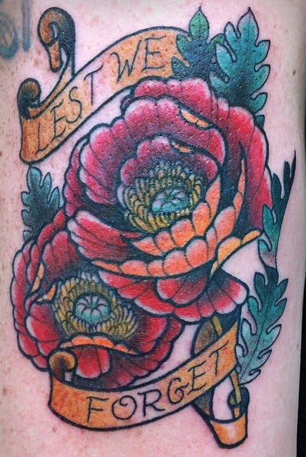 Lest we forget: this sentence and poppies are the symbols of remembrance of war heroes in English-speaking countries. Tattoo by Angie Fey.