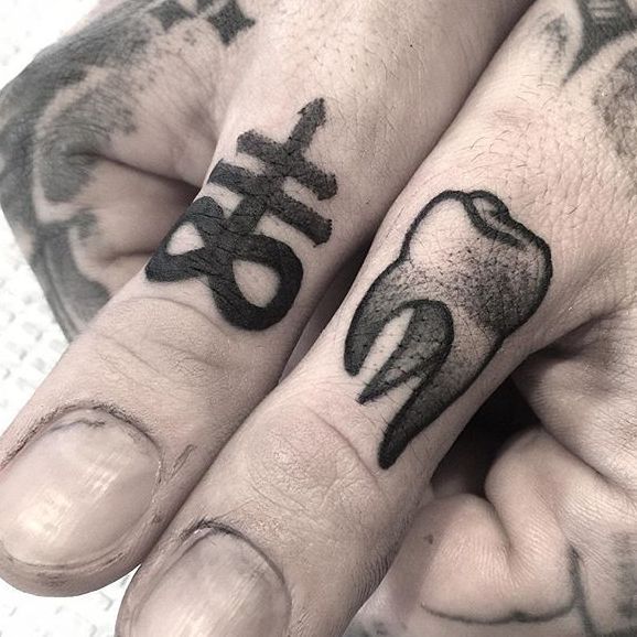 Tooth tattoo located on the wrist illustrative style