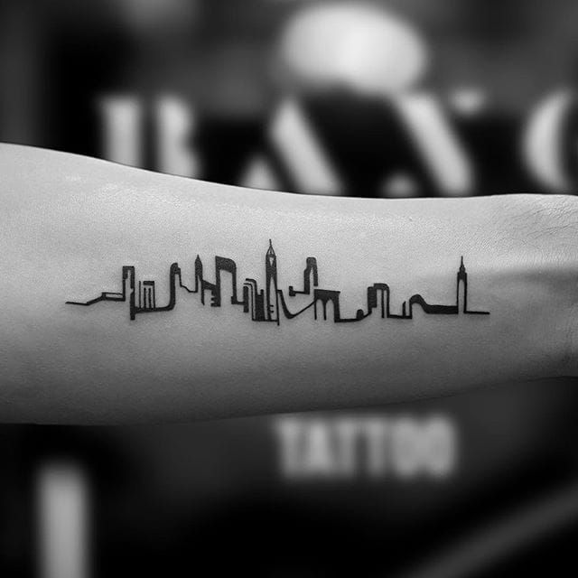 Fine line New York Skyline tattoo on the inner forearm