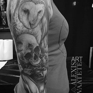 owl holding skull tattoo