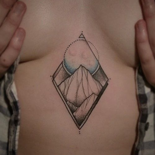 Elegant and discreet low-cut mountain tattoo by Martin Buechter. #mountain landscape #sternum #dotwork #linework #MartinBuechter