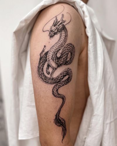 Get inked with a stunning illustrative dragon design by Alex Caldeira for a truly captivating tattoo experience.