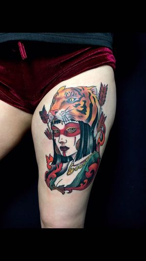 Stunning upper leg tattoo featuring a fierce tiger and elegant woman, beautifully executed by tattoo artist Sandro Secchin.