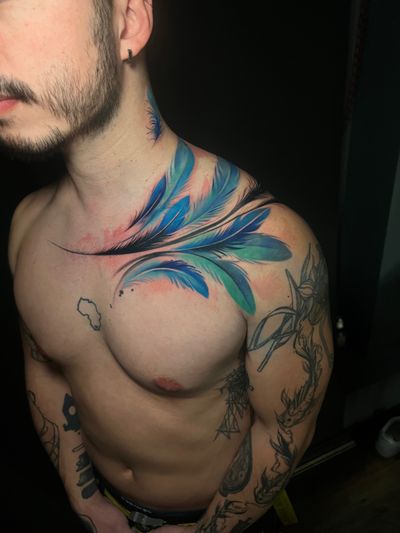 Get a stunning illustrative watercolor tattoo of a feather by the talented artist Cloto. Embrace your inner free spirit with this beautiful design.