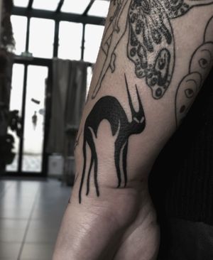 Experience the mystery and elegance of a black cat in this stunning blackwork tattoo by Amandine Canata. Perfect for feline lovers.
