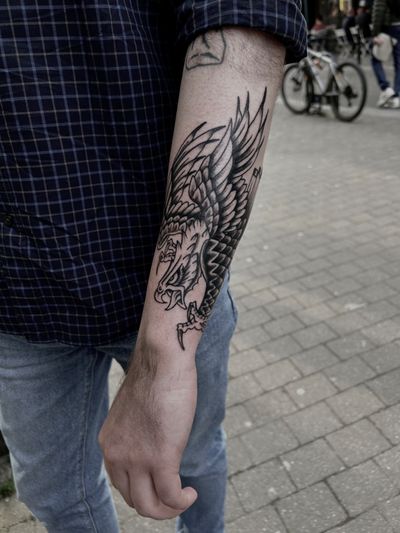 A striking black-and-gray eagle tattoo in a traditional style by artist Barney Coles.