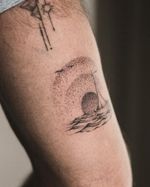 Handpoked • dot by dot Custom design, soft warm sun behind a sailing ship. Done @debutstudios Flash and custom designs Welcome To inquire or book in, please DM or use the link in Bio. #hanpoketattoo #handpokelondon #miltonkeynestattoo #londontattoo #waves #sunsettattoo #texturedtattoo #abstracttattoo