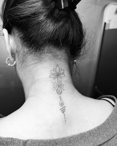 Inna's ornamental fine line tattoo features a delicate lotus flower design.