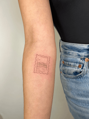 Fine line tattoo by Emma InkBaby featuring a postal stamp motif in illustrative style.