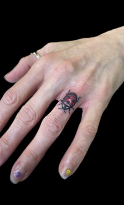 Ladybug finger tattoo 