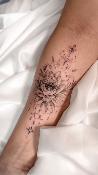 Get a stunning floral tattoo with a beautifully detailed lotus flower design by renowned artist Alex Caldeira.