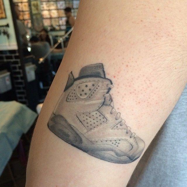 Microrealistic style Air Jordan 1 tattoo located on