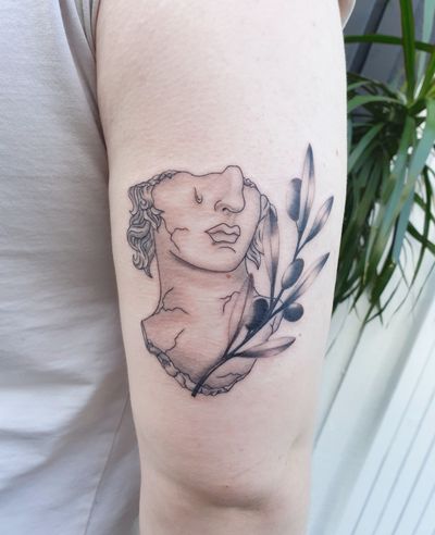 A beautiful fusion of styles featuring an ilustrative greek statue and a realistic olive branch Both made with a lot of care to create a perfect match #finelinetattoo #olivebranch #blackandgrey