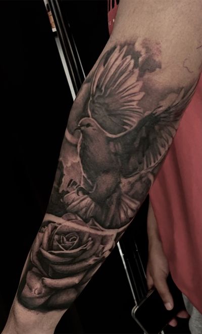 Realistic tattoo featuring a dove and rose by Cara Hayward, expertly done in chicano style.