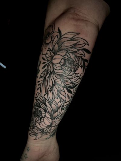 Embrace the beauty of nature with this intricate blackwork tattoo by Ben Twentyman. The detailed chrysanthemum design is sure to make a statement.