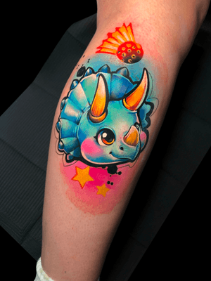 Illustrative and adorable tattoo of a cute triceratops, designed by Cloto.tattoos in watercolor style.