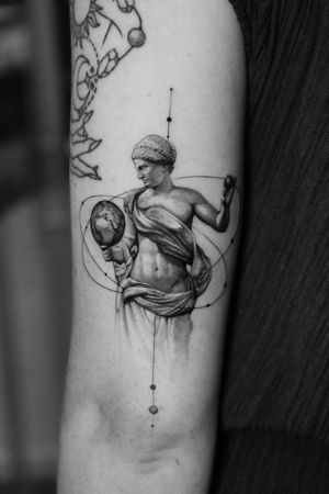 Experience the beauty of fine line and micro realism with this majestic black and gray tattoo by Light Grays. A unique blend of planet and Greek mythology motifs.