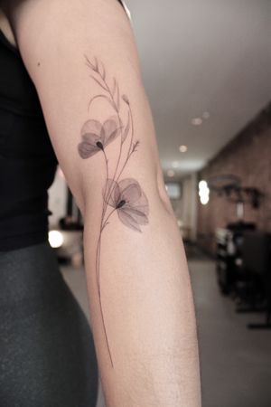 Delicately detailed black and gray floral tattoo by Ayala, showcasing a unique x-ray inspired motif.