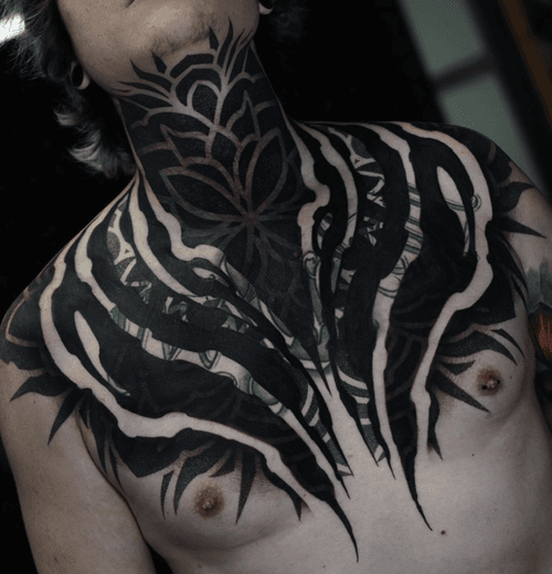Geometric Chest and Neck Tattoo