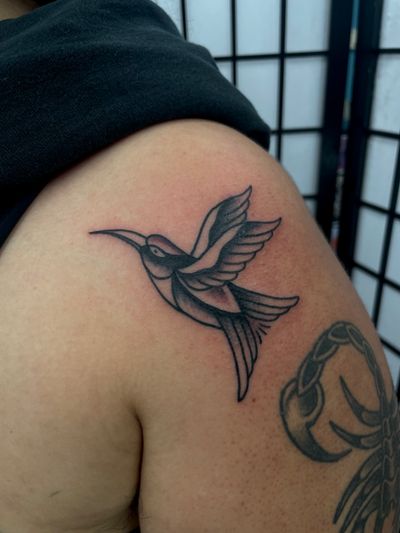 Get a timeless hummingbird tattoo in traditional style by the talented artist Marc 'Cappi' Caplen.