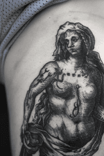 This tattoo features a woman in a classic renaissance style. The shading and cross-hatching technique give it a vintage and artistic appearance. The tattoo has a classical and elegant feel.