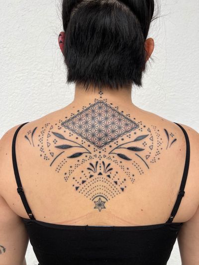 A stunning blackwork tattoo by Cecelia Ercolino, featuring intricate geometric and ornamental patterns.